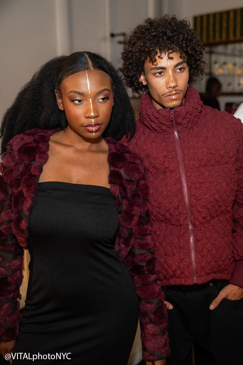 Two looks before the walk: a plush burgundy jacket over a black dress, and a burgundy quilted puffer
