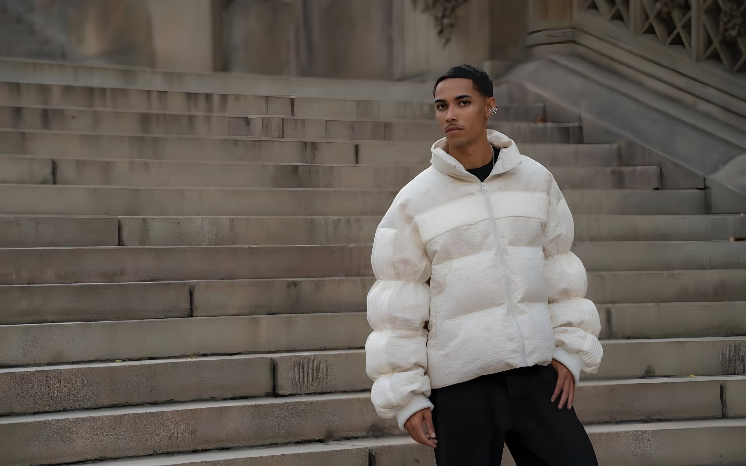 A cream panelled puffer worn on stone steps in daylight.
